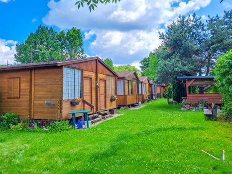 Camping house, row of small wooden huts or houses on green valley. Zadni Treban photo
