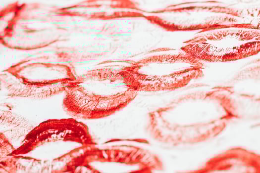 Imprint of red lips on white paper, kiss background photo