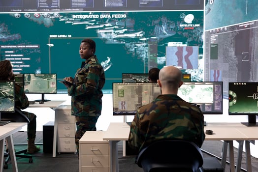 Female master sergeant gathers battlefield intelligence reports on a big screen, creating new plans for secret war operations. Reconnaissance division ensuring national safety in army power base. photo