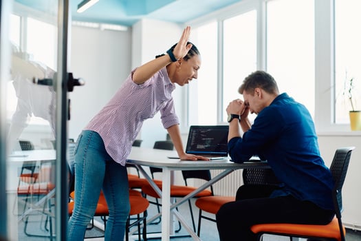 A furious business director of a startup office berating her employee for business mistakes and errors photo