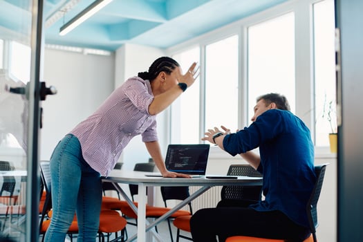 A furious business director of a startup office berating her employee for business mistakes and errors photo
