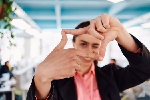 Closeup of hands, Smiling Business Woman Making Frame Gesture with at modern bright coworking open space startup office photo