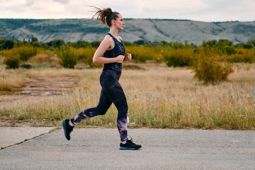 Determined Athlete Running in the Sun amidst Beautiful Nature photo