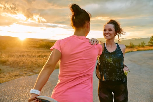 Two Women Athletes Stretching at Sunset in Beautiful Natural Surroundings photo