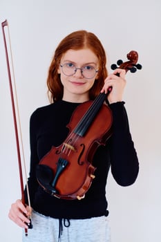 Stunning Redhead Musician Poses with Violin in Captivating Portrait photo
