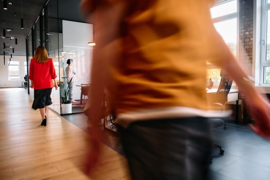A diverse group of business professionals collaborates in a modern startup coworking center, utilizing a mix of paper-based and technological tools such as mobile phones and computers photo