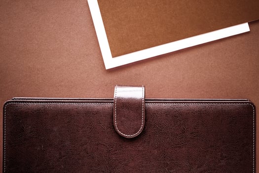 Vintage business briefcase on the office table desk, flatlay background photo