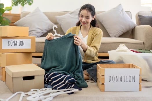 Volunteer Sorting and Donation Clothes for Charity - Community Service and Generosity in Action, Helping Those in Need with Clothing Donations, Social Responsibility and Kindness photo