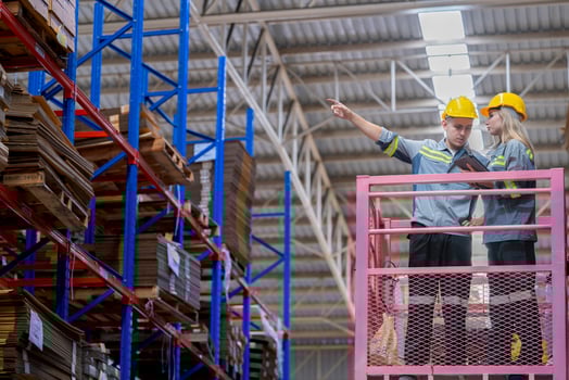 workers man and woman using a hydraulic scissor lift to check stock near the shelves warehouse. industry factory warehouse. Worker Screening Package In Warehouse. photo