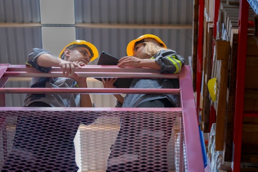 workers man and woman using a hydraulic scissor lift to check stock near the shelves warehouse. industry factory warehouse. Worker Screening Package In Warehouse. photo