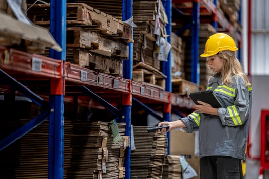 woman worker walking and checking stock items for shipping. Female inspecting the store factory. Logistics employees holding folders at on site warehouse area for shipping transportation. photo