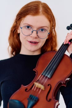 Stunning Redhead Musician Poses with Violin in Captivating Portrait photo