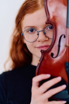 Stunning Redhead Musician Poses with Violin in Captivating Portrait photo