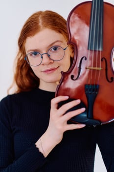 Stunning Redhead Musician Poses with Violin in Captivating Portrait photo