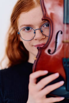 Stunning Redhead Musician Poses with Violin in Captivating Portrait photo