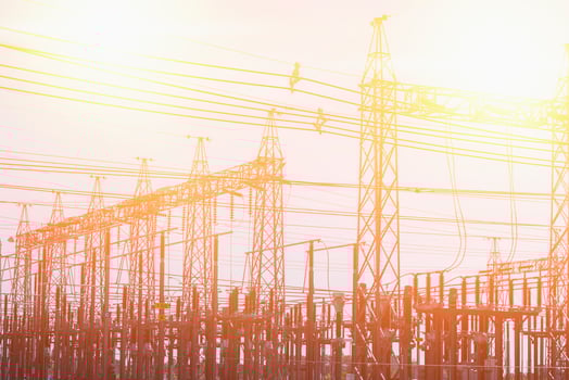 High voltage towers at sunset background. Power lines against the sky photo