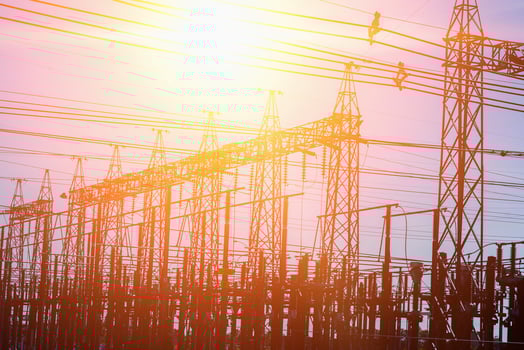 High voltage towers at sunset background. Power lines against the sky photo