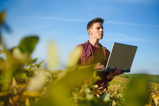 Young farmer in soybean fields photo