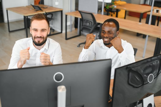 Two confident businessmen, financial analysts or investment advisers sitting at office desk photo