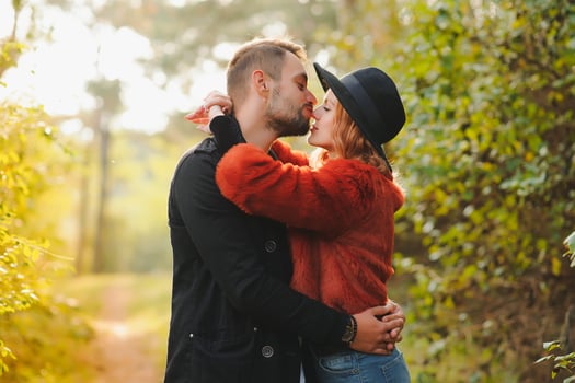 Kissing young couple in love in the autumn park. photo