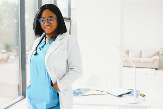 beautiful african american female pediatric nurse in modern office. photo