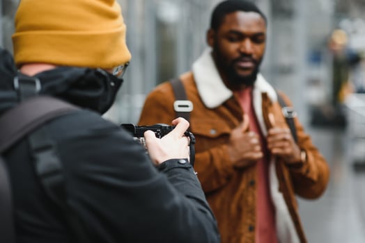 portrait of confident trendy serious african guy in stylish outfit, young afro american male posing at camera, looking away photo