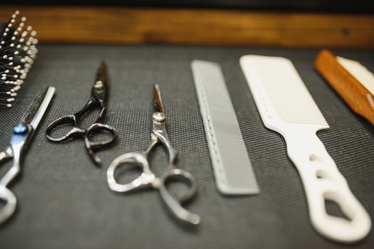 Vintage barber shop tools on old wooden background photo