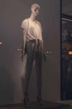 Female mannequin in summer clothes in the window of a fashion store photo