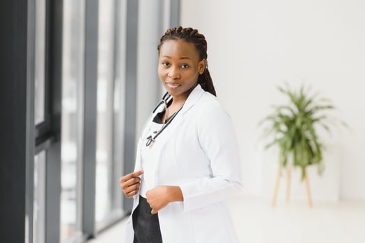 Portrait of female African American doctor standing in her office at clinic. photo