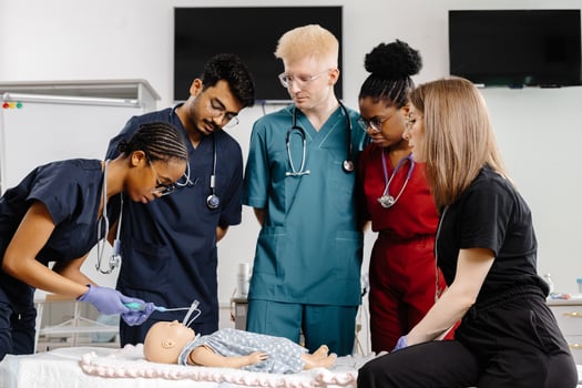 Medical Students Practicing Resuscitation on a Training Dummy photo
