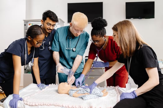 Medical Students Practicing CPR on a Baby Mannequin photo