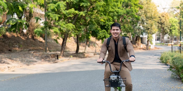 Businessman Riding Bicycle to Work in Urban Park, Embracing Eco Friendly and Sustainable Transportation for a Greener Future photo