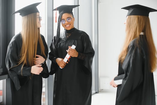 portrait of multiracial graduates holding diploma photo