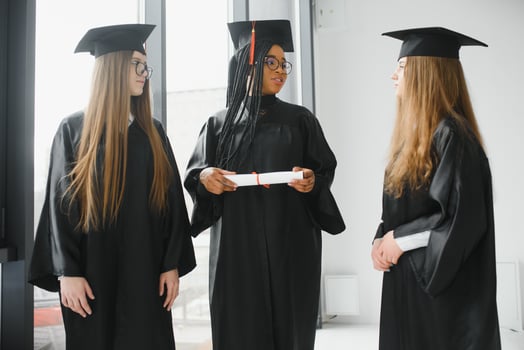 portrait of multiracial graduates holding diploma photo
