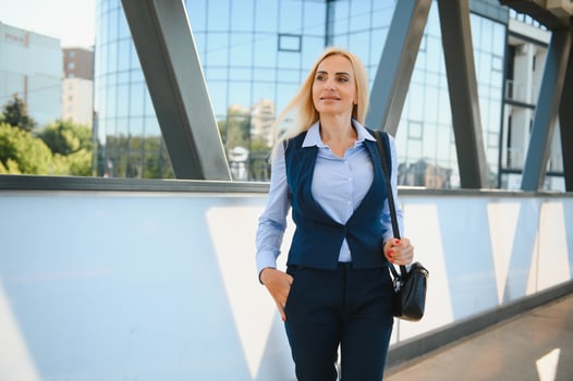 Beautiful Woman Going To Work, Business Woman Walking Near Office Building. Portrait Of Successful Business Woman. photo