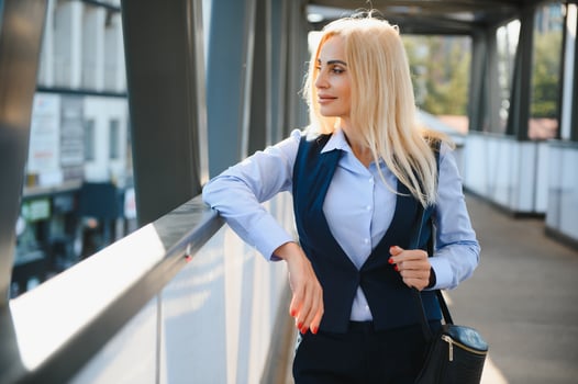 Close up portrait of a serious business woman in blue suit standing in the city photo