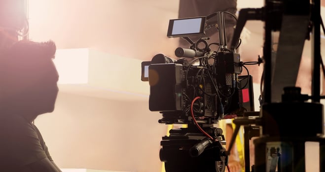 Filmmaker crew team with professional cinema equipment and film camera on the set. Film director and crew making commercial content advertising in studio. Technique of modern filming and advertising. photo
