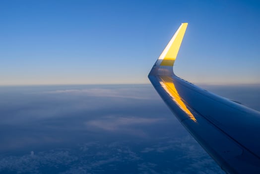 Airplane wing above clouds photo