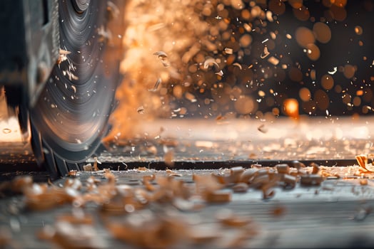 A close-up of a silver circular saw cuts a wooden block, chips fly in different directions photo