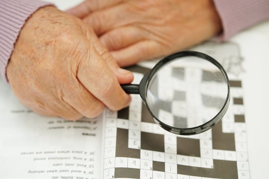 elderly woman playing sudoku puzzle game for treatment dementia prevention and Alzheimer disease. photo