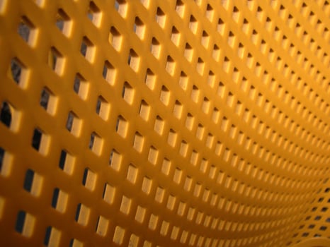 a close up of a yellow plastic chair photo