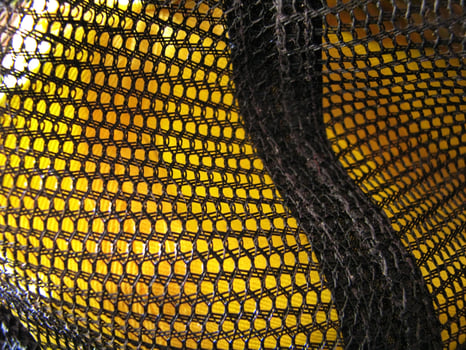 a close up of a yellow and black mesh bag photo