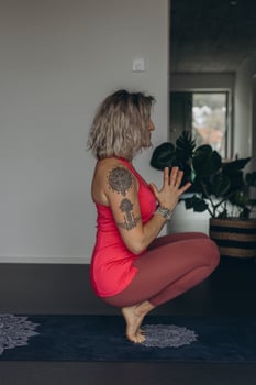 Attractive young woman practing yoga stretching yoga at home. photo
