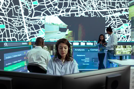 Female employee operates on satellite map CCTV radar to monitor delivery trucks and cargo, ensuring express shipping service. Dispatcher uses global positioning system to locate couriers. photo