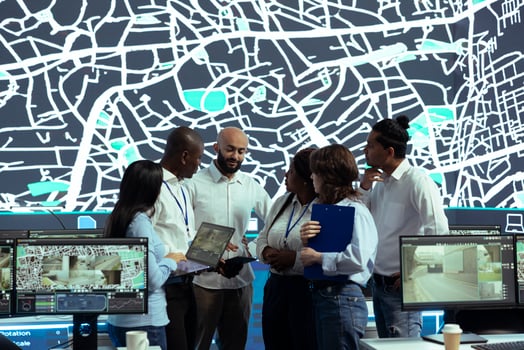 Diverse team of operators analyzing parcel awb and logistics to ensure order tracking service within the delivery app. Employee following truck drivers via gps coordinates on digital map. photo