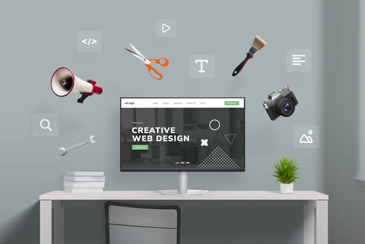Web design studio with flying tools and web page icons around computer display featuring concept agency page. Creative illustration of digital workspace photo