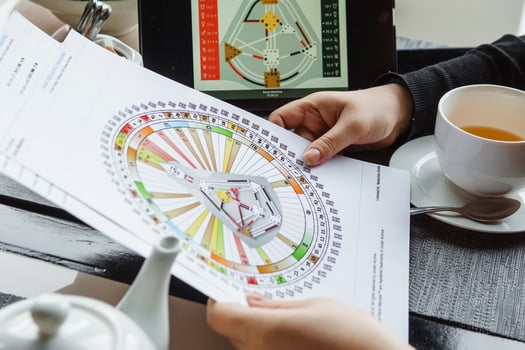 TVER, RUSSIA - FEBRUARY 12, 2023. A woman at the table is studying a rave mandala by human design. Rave mandala on the table close-up. The concept of esoteric teachings. photo