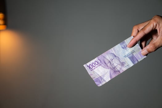 Hand holding 1000 South African Rand banknote photo