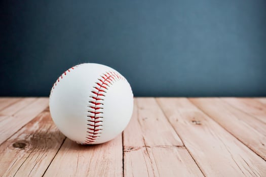 White and red colored baseball curveball equipment. Object photography isolated on horizontal ratio wooden surface background. photo