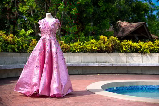 a pink dress is on display near a pool photo